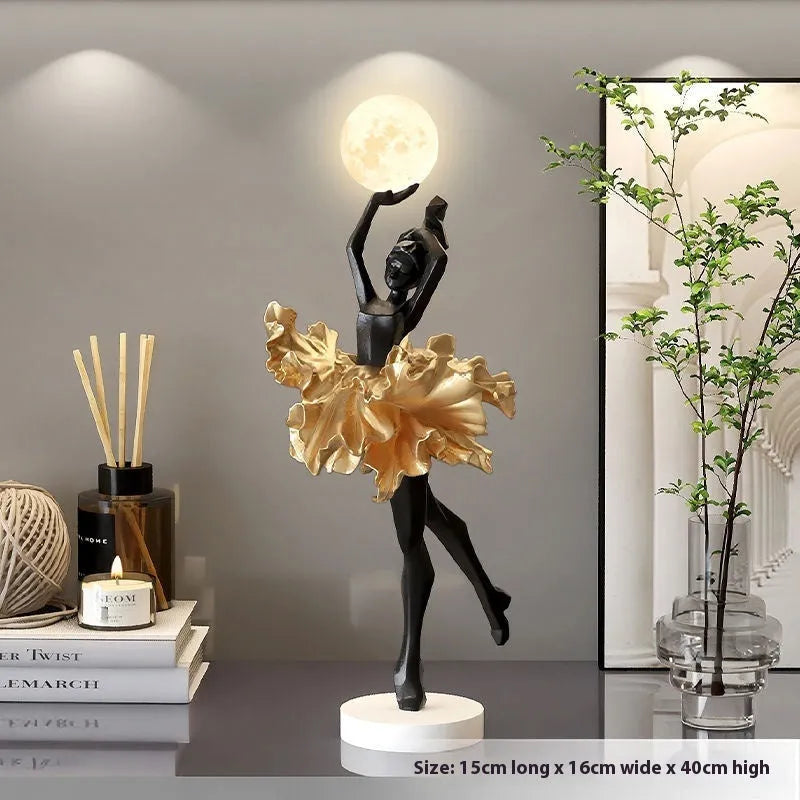 Modern art girl style resin night light with USB charging cable in black gold colour.