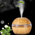 Compact brown wood grain USB humidifier with 200ml water tank on a desk.