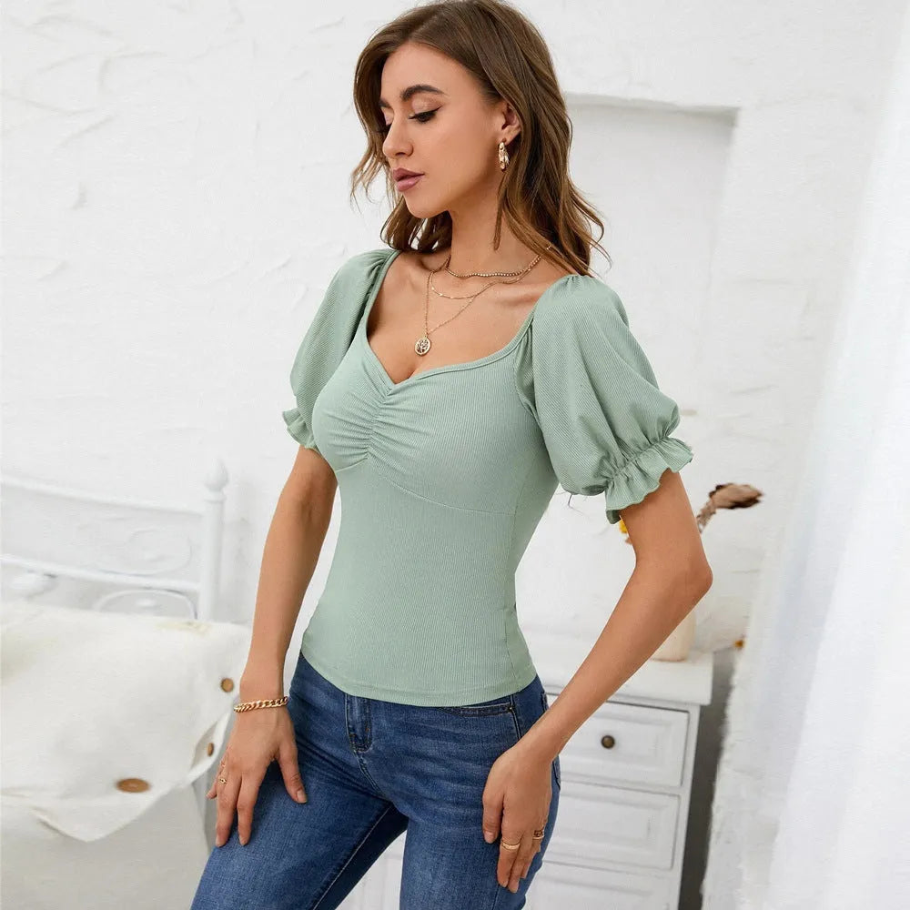 Women's slim-fit light green knit top with puff sleeves and waist cinching shirring