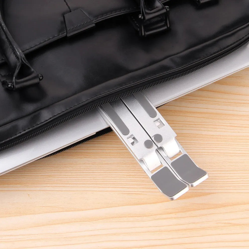 Silver aluminium alloy cooling folding computer stand for laptops under 16 inches on a desk