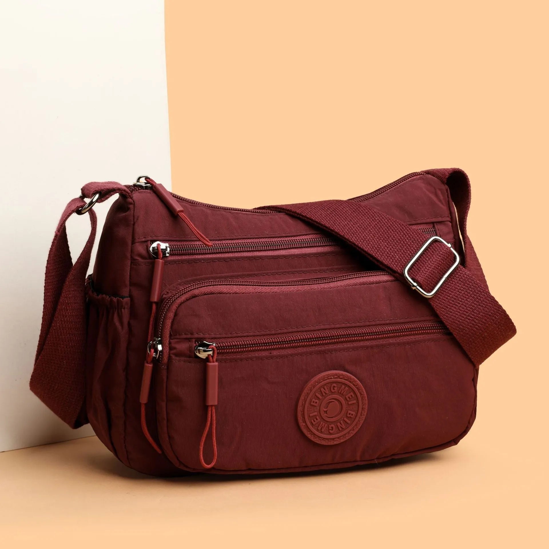 Soft water-repellent nylon crossbody bag showing three-dimensional pocket and adjustable shoulder strap