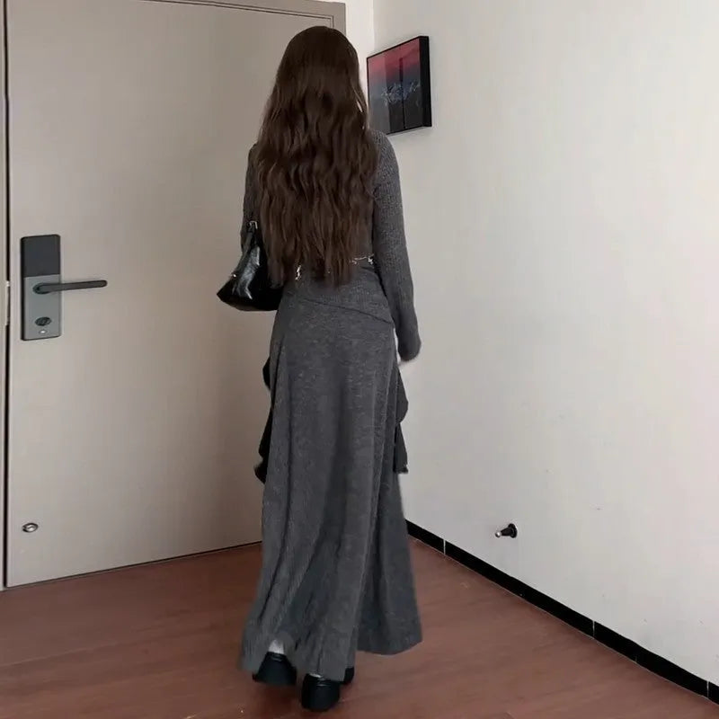 Women's gray knit dress set with neck-hanging top and long patchwork skirt on a model