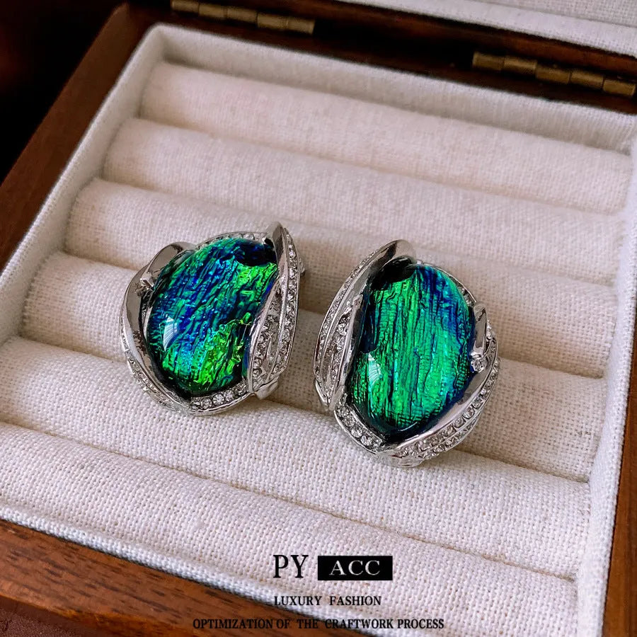 Silver resin stud earrings with rhinestone encrusting and irregular retro shape in silver needle green