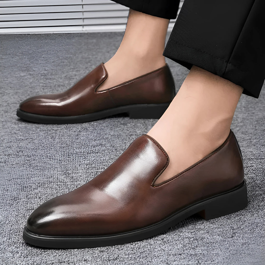 Men's polished pointed black leather shoes with leather toe cap and rubber sole, side view