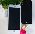 iPhone LCD screen replacement display with capacitive touch, shown with a black frame and a disassembly tool.