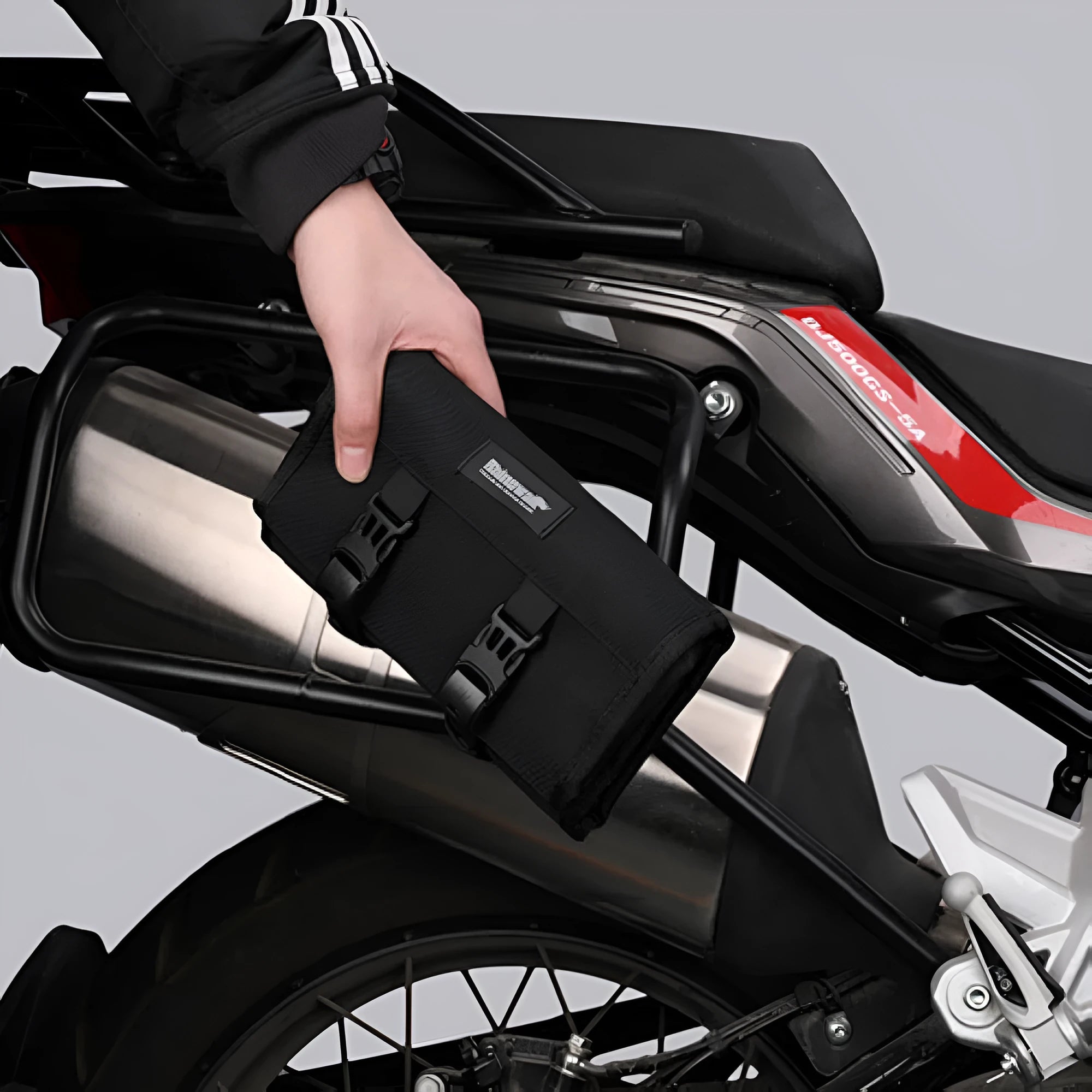 Motorcycle repair kit storage organiser in black, unfolded to show elastic straps and mesh zipper bag