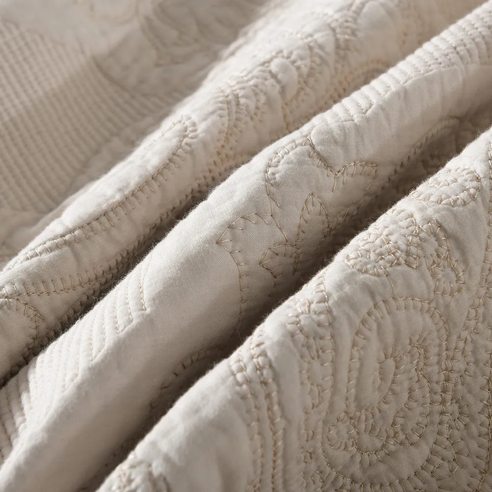 Three-piece pure cotton quilted bed cover set in white with Nordic floral embroidery on a 1.8m bed