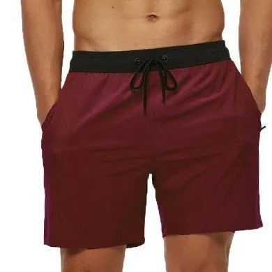 Men's blue polyester active shorts with a drawstring waist and zipper pocket.