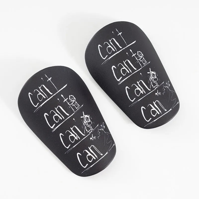 Football training shin guards in PU material showing black, blue, white, and white-black colour options