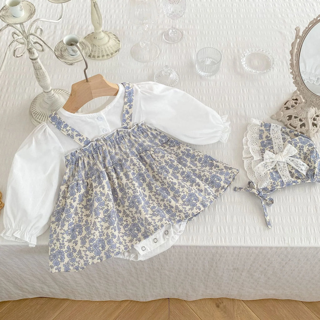 White cotton baby girls' floral princess romper with long sleeves, pullover closure, and removable hood in triangle jumpsuit style