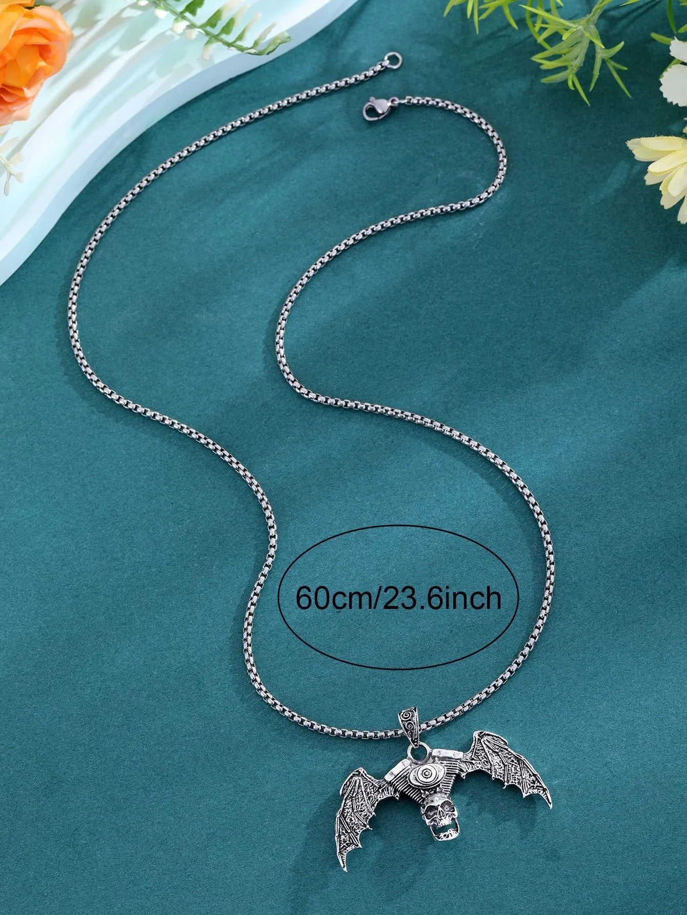 Gothic dark alloy skull pendant necklace with skeleton wing detail on matte black background