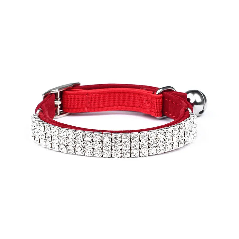 Red velvet cat collar with a line of sparkling rhinestones, showing the adjustable buckle.
