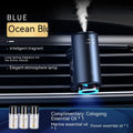 Smart car aroma diffuser clipped onto car air vent in obsidian black colour with essential oil bottles