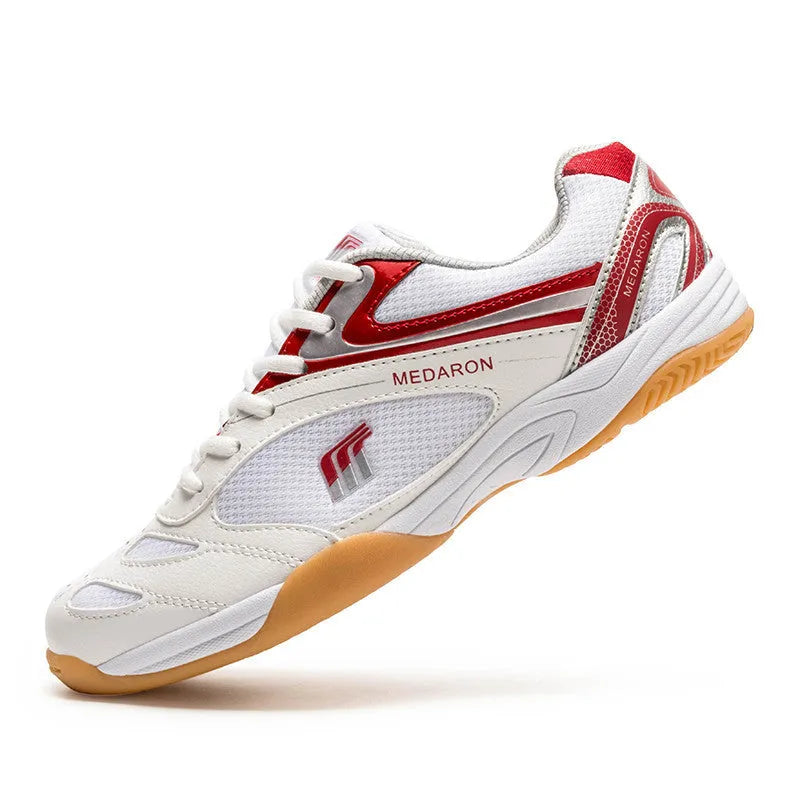 Table tennis training sneaker in white and blue with synthetic leather and mesh upper and lace-up front.