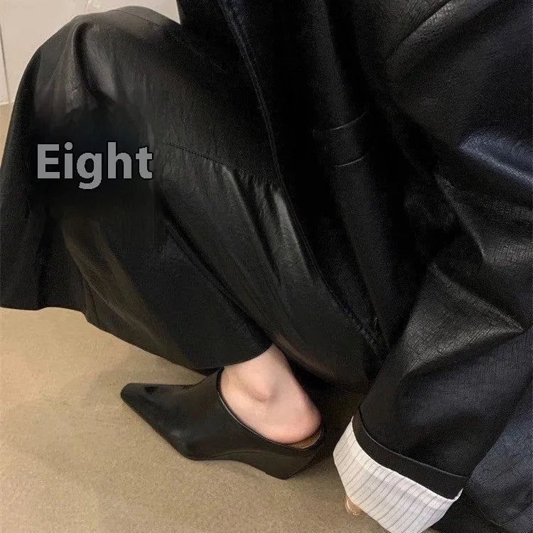 Women's black closed toe wedge half slippers showing PU upper material and wind wedge sole design