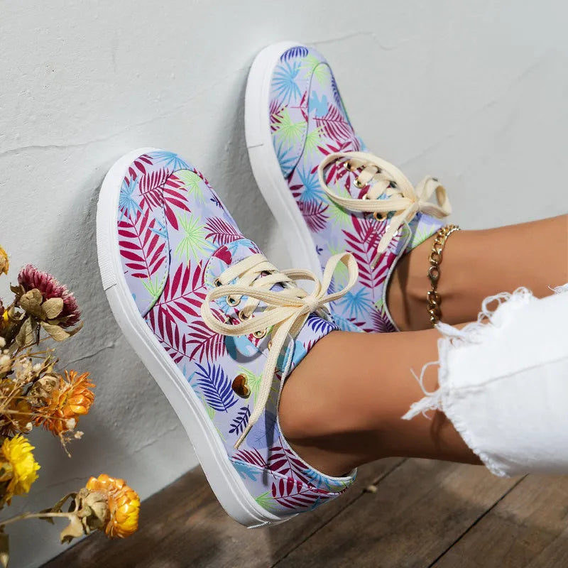 Light blue women's canvas lace-up flats with graffiti leaf print and round toe