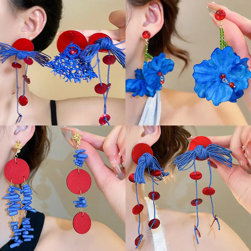 Women's handmade geometric drop earrings with blue resin flower in silver needle colour