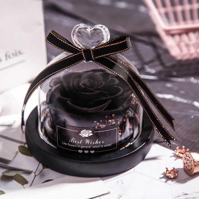 Glass dome containing a preserved red eternal rose illuminated by a soft LED light