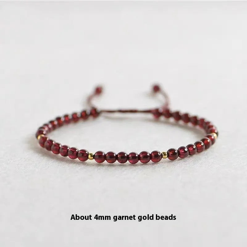 Hand-woven garnet red rope bracelet made from flexible wire, showing national tide style.