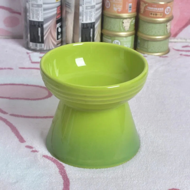 White ceramic pet bowl with a high foot base and wide, shallow eating area for dogs and cats