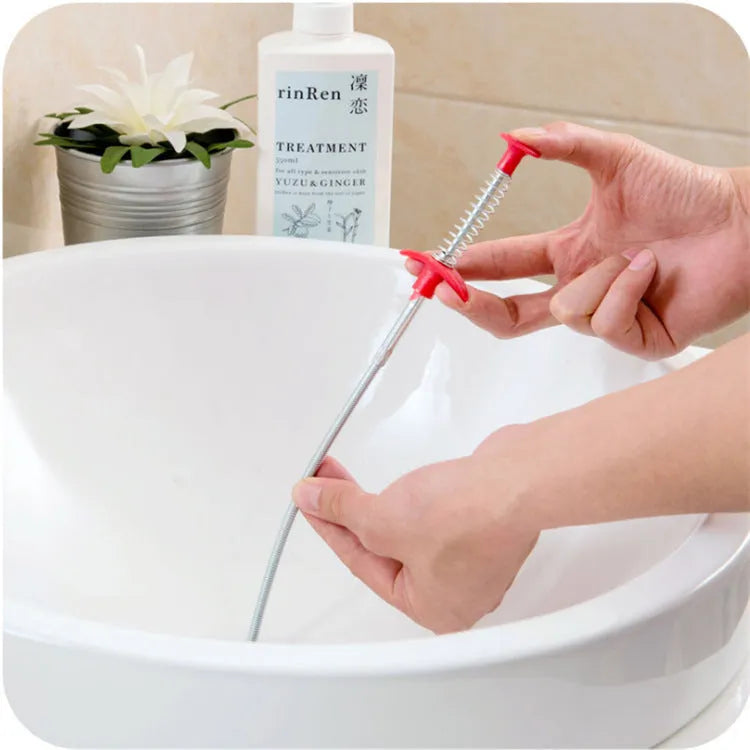 Flexible drain cleaning spring tool with gripped handle for removing hair from pipes