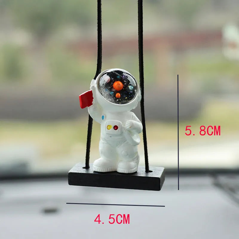 Cartoon style resin astronaut car pendant in five different colour and design variants.