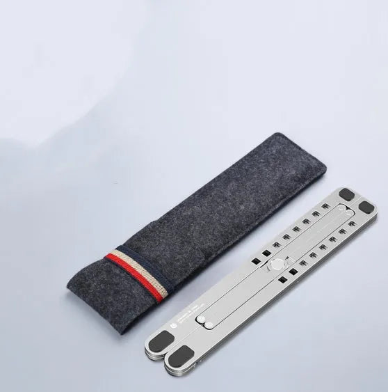 Silver foldable aluminium laptop stand holding a MacBook at an adjusted angle