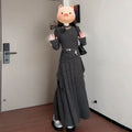 Women's gray knit dress set with neck-hanging top and long patchwork skirt on a model