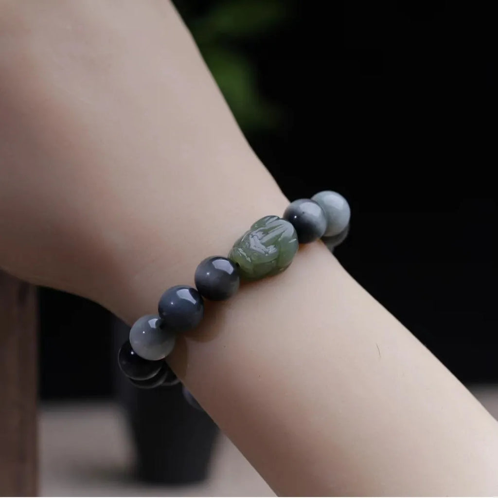 Black bracelet with 10mm Eagle Eye stone beads and a Hetian Jade Pixiu charm.
