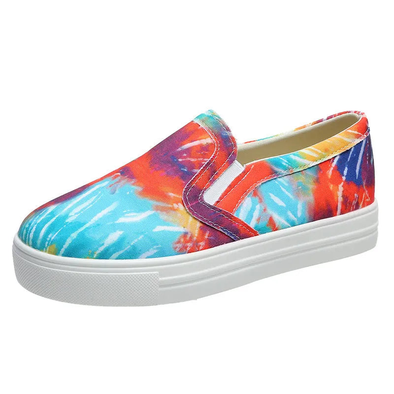 Women's low-top canvas trainers in multiple colours with flat rubber sole.
