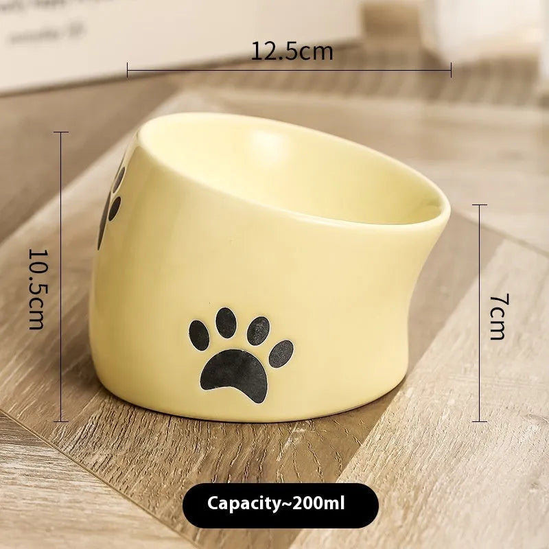 Ceramic cat bowl with cat paw design in black, showing oblique mouth style.