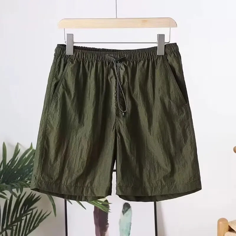 Men's thin quick-drying polyester sports shorts in straight leg style, shown in army green colour.