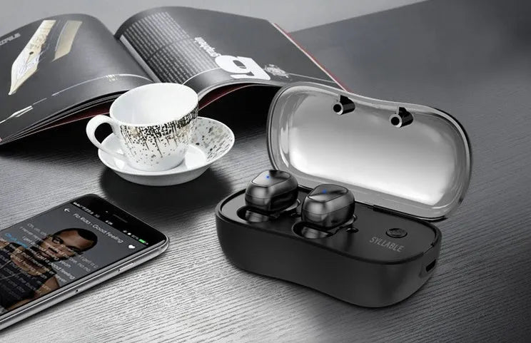 White TWS wireless in-ear sports headphones and compact rectangular charging case on a table.
