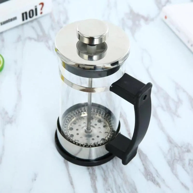 Compact stovetop espresso maker with glass upper section and stainless steel base