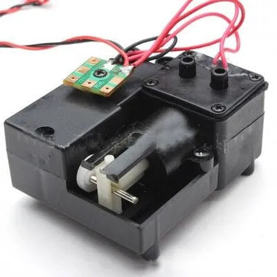 Black electronic smoke box accessory for 1/16 scale RC tank models on a grey surface.
