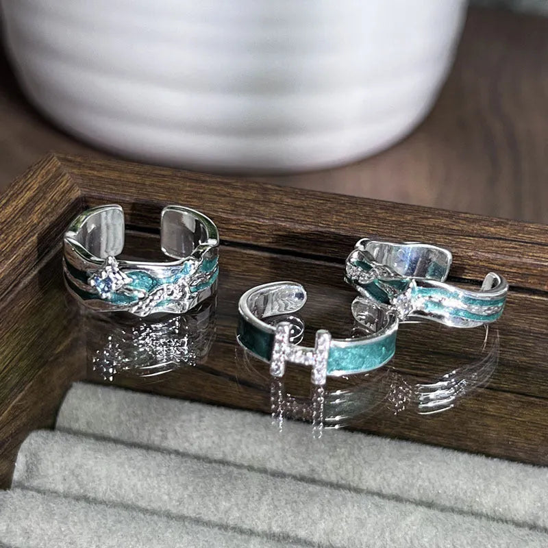 Mint green enamel asterism ring with asymmetric folded copper design and eight-point star pattern