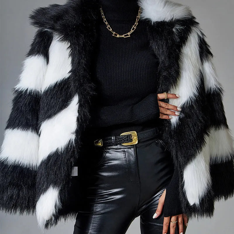 A picture colour faux fur coat with a contrast lapel and a textured fur collar, shown on a hanger.