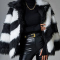 A picture colour faux fur coat with a contrast lapel and a textured fur collar, shown on a hanger.
