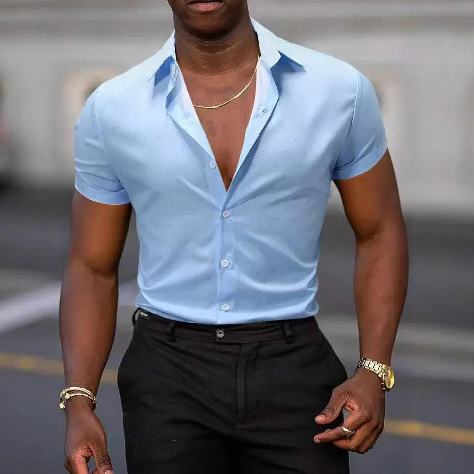 Man wearing a light blue short-sleeved casual shirt with a floral print pattern.