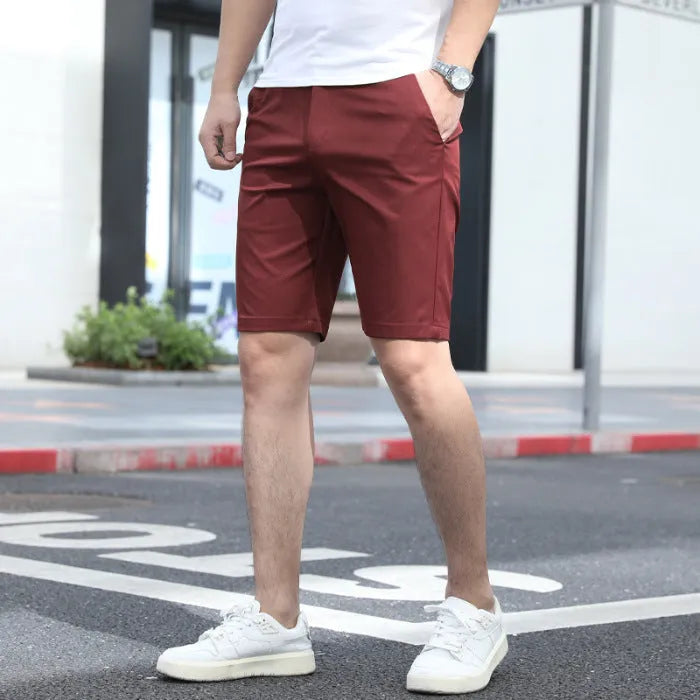 Men's loose elastic mid-length fifth pants in a solid colour on a hanger.
