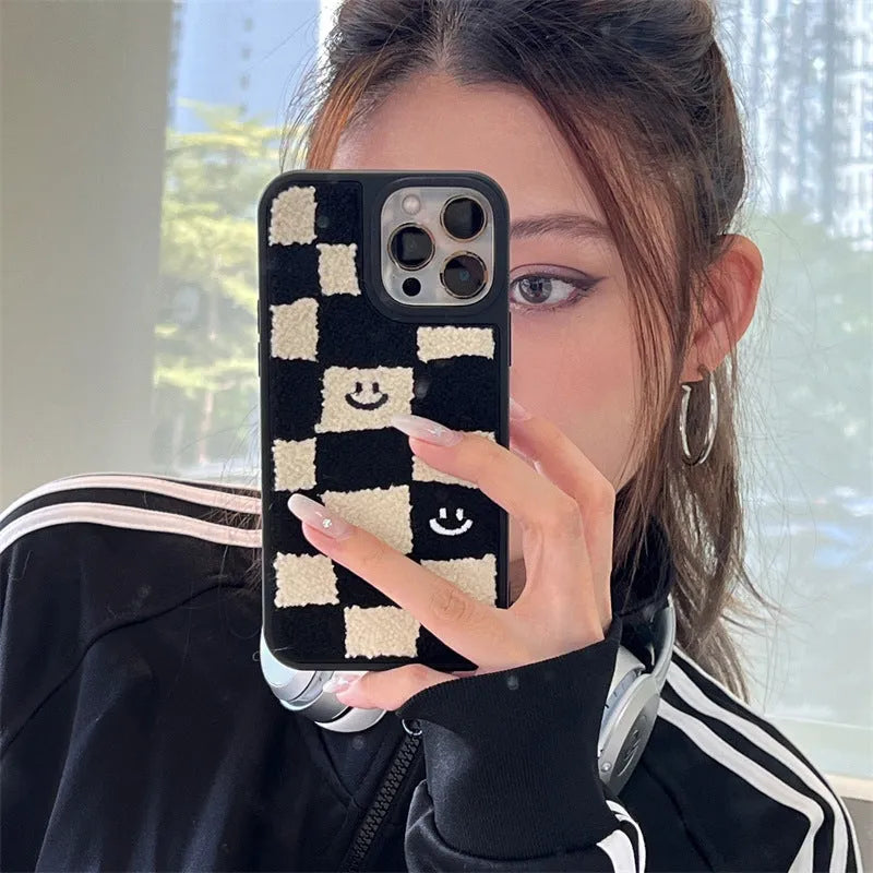 Black and white chessboard TPU phone case for iPhone with precise cutouts on a white background