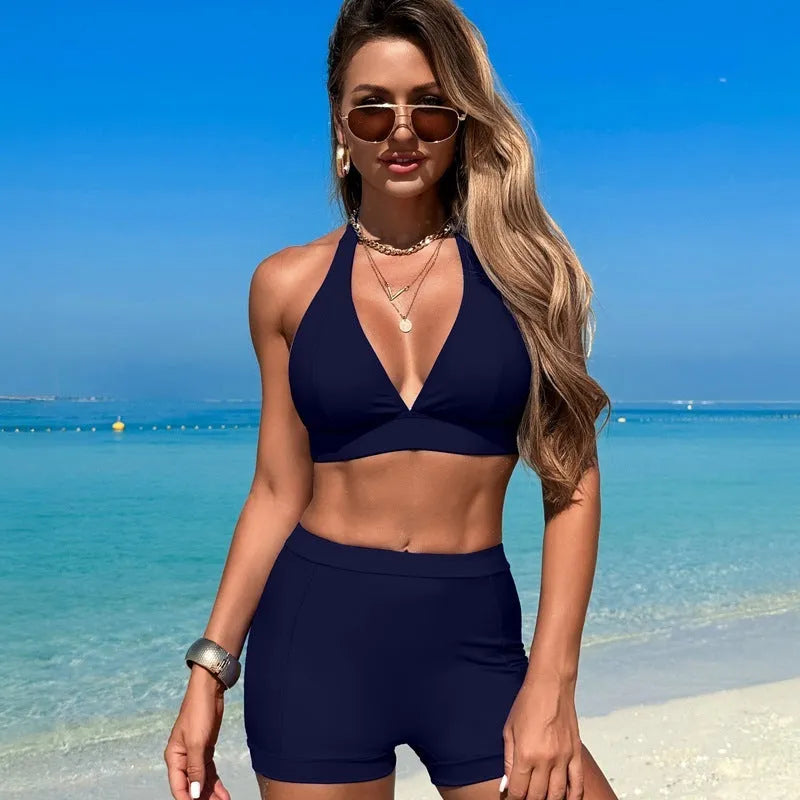 Women's black split bikini swimsuit laid flat, showing two-piece design.