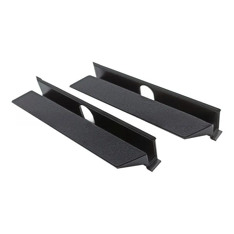 Black PS4 Pro hard drive bottom cover and internal service parts including a baffle and block strip.