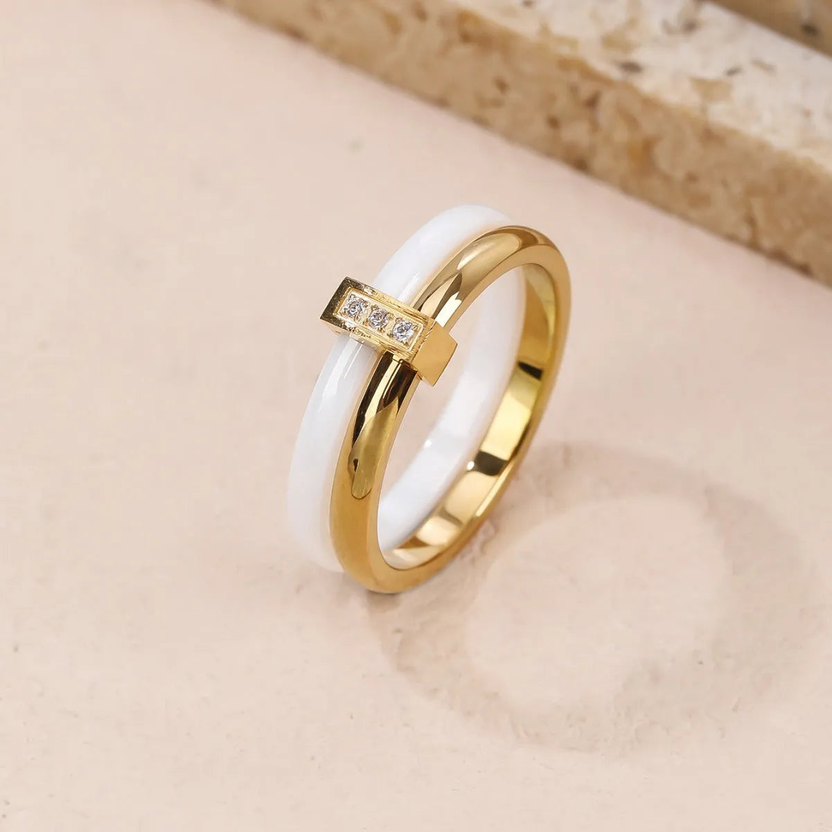 A glossy titanium steel women's double ring with a heart-shaped zirconium inlay, shown in steel white colour.