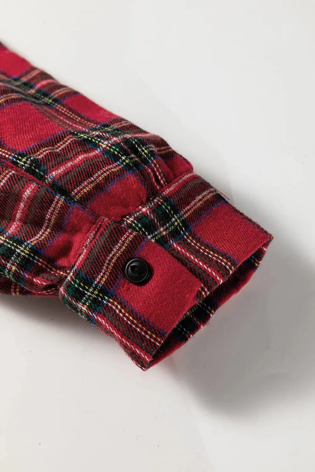 Red plaid mini dress with a shirt collar, long sleeves, half-button front, and a ruffle hem.