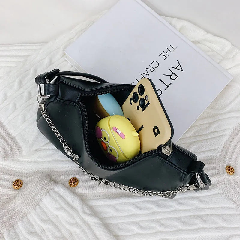 Retro-style light blue underarm shoulder bag with a silver butterfly chain strap, shown worn crossbody.