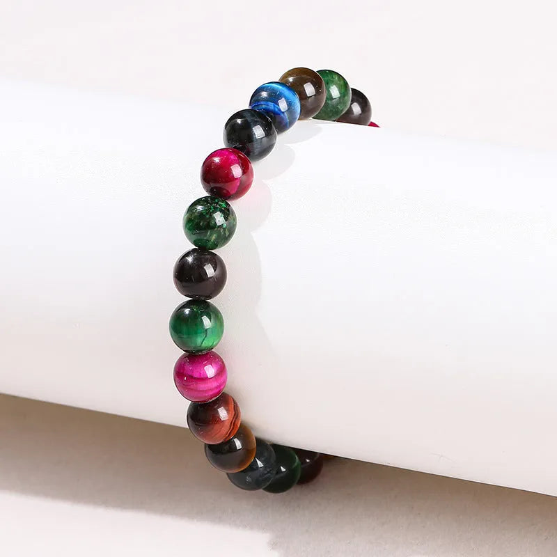 Colourful Tigereye natural stone bracelet with geometric round beads in multiple sizes on wrist