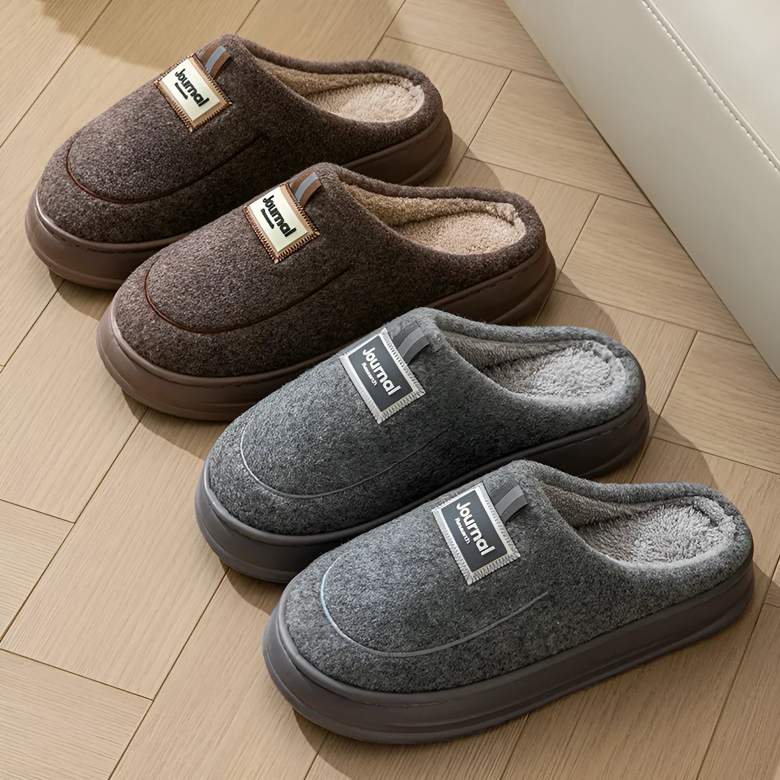 Men's brown suede slippers with a thick, textured sole on a wooden floor