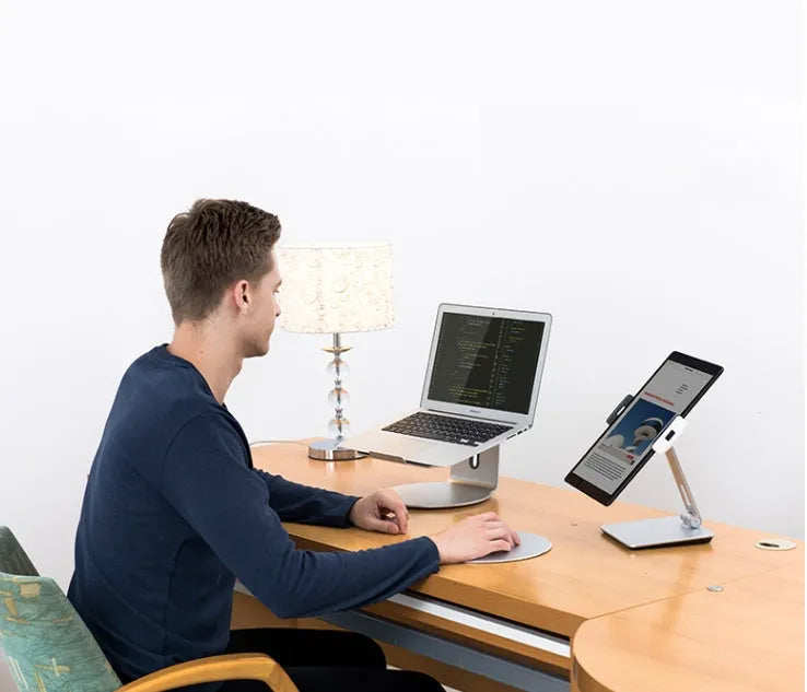 Silver foldable aluminium phone tablet holder on desk showing 360° rotation