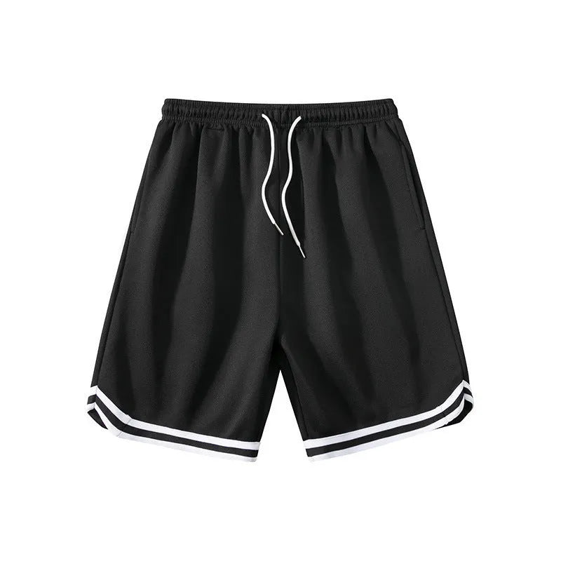 Man wearing loose-fit apricot coloured polyester sports shorts with an elastic waistband.